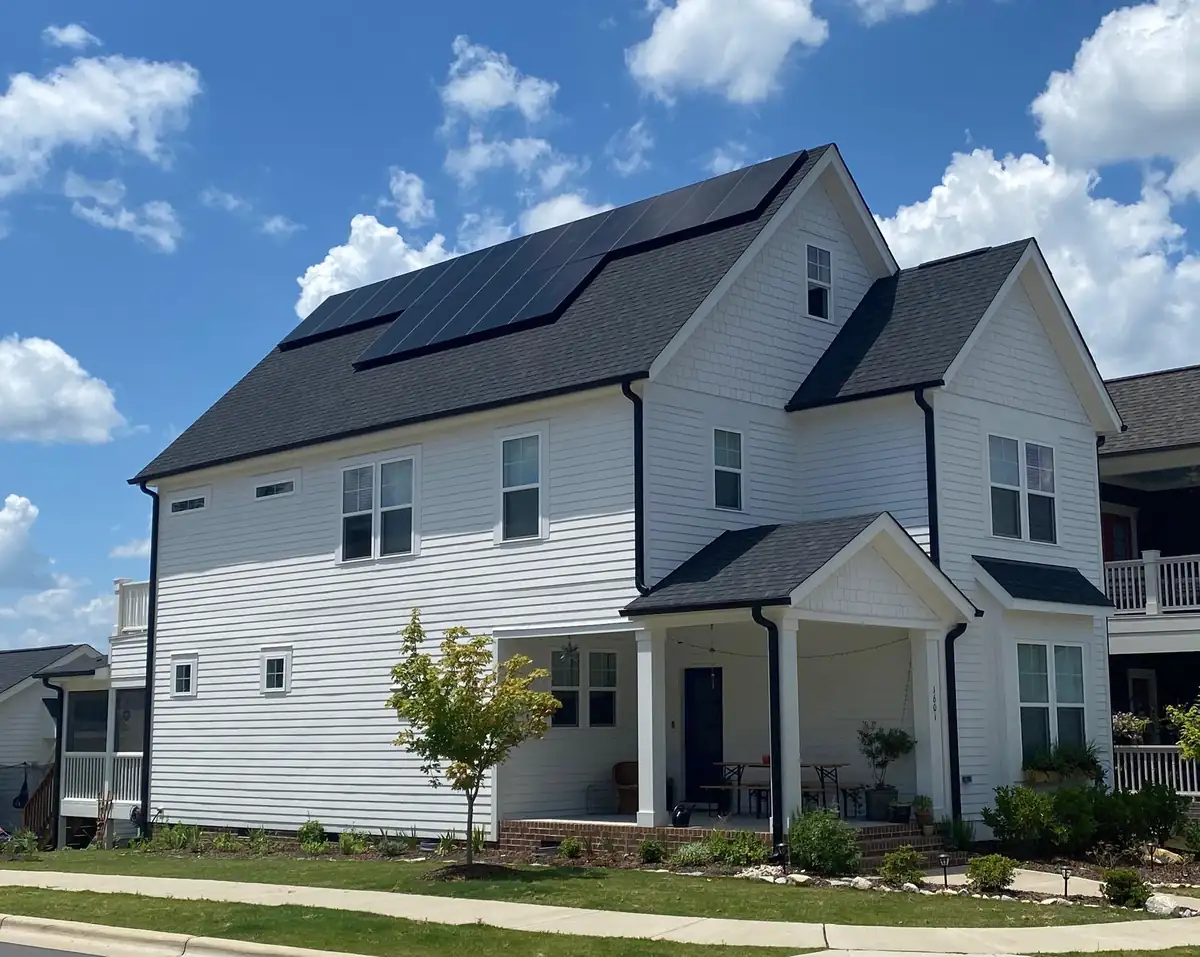 North Carolina suburban home with rooftop solar panels and a home battery